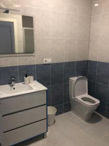 a bathroom with a toilet and a sink and a mirror at A esmorga in Ourense +28 photos