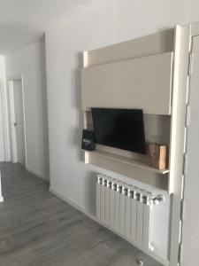 a living room with a tv on a wall at A esmorga in Ourense