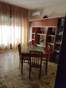 - une salle à manger avec une table et des chaises en bois dans l'établissement Appartamento Elisa, à Melito di Porto Salvo