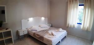 A bed or beds in a room at blue & white askeli studios