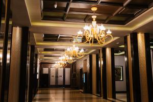 a hallway in a building with a chandelier at Hotel Dukagjini in Peje