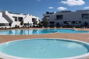 a large swimming pool in front of a building at Suite Dreams Fuerteventura in Villaverde