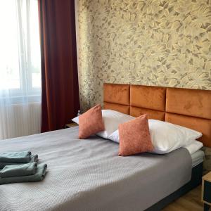 a bedroom with a large bed with two pillows at Apartamenty Teatralne in Gorzów Wielkopolski