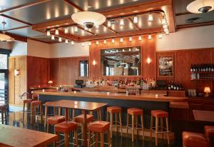 a bar in a restaurant with stools at Ace Hotel Brooklyn in Brooklyn