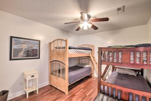 two bunk beds in a room with a ceiling fan at Waterfront Getaway with Fire Pit and Game Room! in Iva