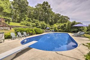 an image of a swimming pool with chairs and umbrellas at Private Guest House with Deck and Spectacular Views! in Uncasville