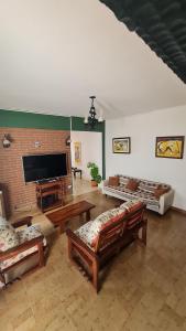 a large living room with couches and a brick wall at Casa de Güemes Salta Capital in Salta