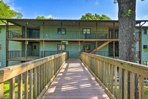 a boardwalk leading to the front of a building at Reeds Spring Condo Near Aquarium at the Boardwalk! in Reeds Spring