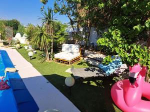 a backyard with a swimming pool and a chair and a pool at SUITE-Junior -Villa HÉLÈNE - Montpellier Sud - aéroport- PISCINE Privée-2mn des plages in Pérols