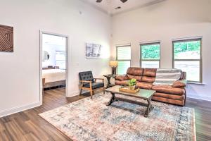 a living room with a couch and a table at Family Friendly Calera Getaway with Game Room! in Calera