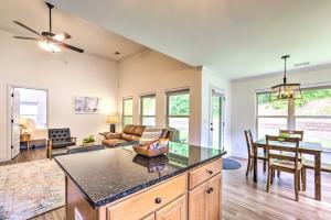 a kitchen and living room with a couch and a table at Family Friendly Calera Getaway with Game Room! in Calera
