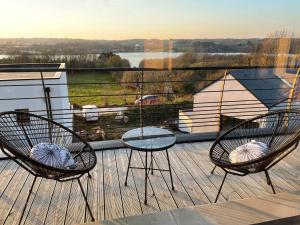 - deux chaises et une table sur une terrasse avec vue dans l'établissement Ô DREFF - Maison au calme avec vue mer, 