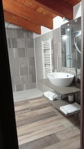 a bathroom with a white sink and a shower at Hotel Ristorante Caligiuri in Decollatura