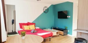 a bedroom with a red bed and a table at The Lagoon - Sublime studio moderne in Dreux
