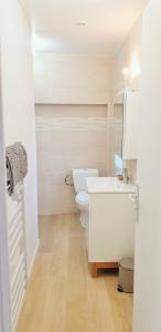 a white bathroom with a toilet and a sink at The Lagoon - Sublime studio moderne in Dreux