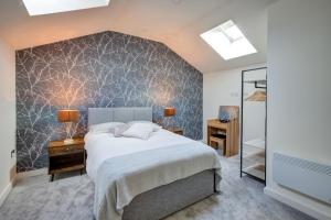 a bedroom with a large bed and a wall at Stylish 'New York Loft' 2 Bed Apartment in Bradford