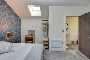 a bedroom with a bed and a bathroom at Stylish 'New York Loft' 2 Bed Apartment in Bradford