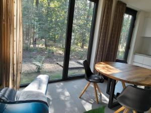 a room with a table and chairs and a large window at Black Box in Lille