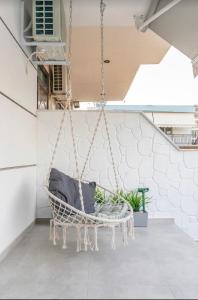 a hanging chair in a room with at IOSIF suites in Neos Marmaras