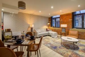 a living room with a couch and a table at Stylish 'New York Loft' 2 Bed Apartment in Bradford