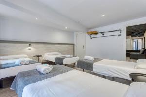 a room with four beds in a room at HOSTAL BEDMATES in Barcelona