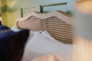 a close up of a bed with a wooden head board at The George & Dragon in Westerham