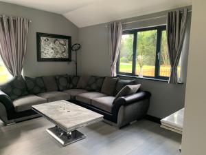 a living room with a couch and a coffee table at Belvedare-Suffolk in Sudbury