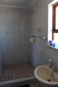 a bathroom with a sink and a shower at Turning Point Bed & Breakfast in Cape Town +61 photos