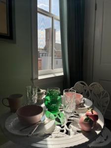 a table with plates and glasses and a window at The Philadelphia Hotel Bella Vista in Philadelphia