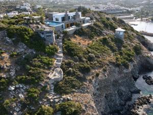 an aerial view of a house on a cliff at Villa Aiolos: above the sea, within Agios Nikolaos in Agios Nikolaos