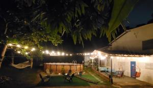 a backyard at night with lights on a house at Hacienda Patria 