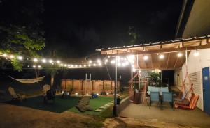 a patio with a pergola at night with lights at Hacienda Patria 