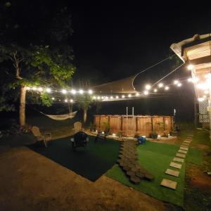a backyard at night with lights and a lawn at Hacienda Patria 