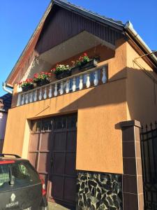 a house with a garage with flower boxes on it at Casa Bis in Sibiu