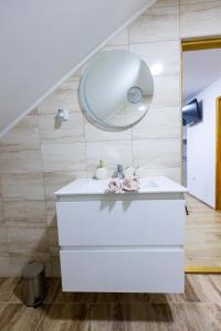 La salle de bains est pourvue d'un lavabo et d'un miroir. dans l'établissement Apartmani Tomšić, à Darda