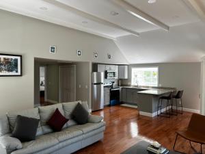 a living room with a couch and a kitchen at Captains Quarters Motel & Conference Center in Eastham