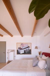 a bedroom with a large white bed with pillows at Villa Aiolos: above the sea, within Agios Nikolaos in Agios Nikolaos