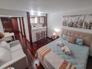 a bedroom with a bed with two towels on it at Atrium Studio Cascais in Cascais