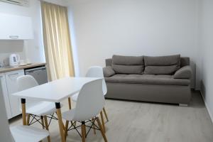 a living room with a couch and a table and chairs at Villa Sandra Lagadin in Ohrid