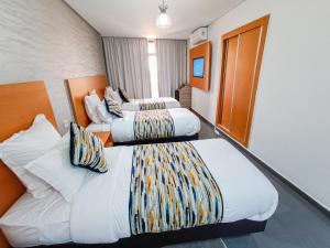 Postel nebo postele na pokoji v ubytování Hotel SunSet Beni Mellal