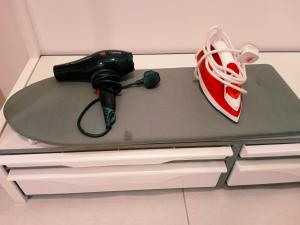 a remote control and a pair of shoes on a table at Comfortable18 3R2B 7pax Meritus Perai in Perai
