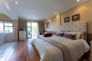 a large bedroom with a large bed in a room at Aestas Bed and Breakfast in Knysna