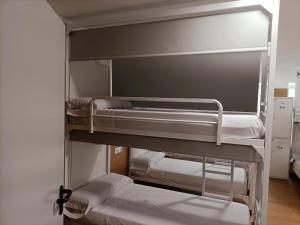 a group of bunk beds in a room at ALBERGUE VALIN LAMA in Palas de Rei +8 photos