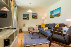 a living room with a couch and a table at Montela Apartments by fewo-plan SAAS210 in Saas-Grund