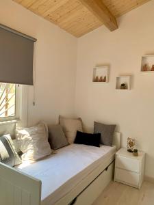 a bed sitting in a room with a window at Flat in Girona City Centre - 5 mins from Old Town and Train Station in Girona +6 photos