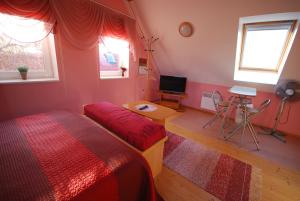 a bedroom with two beds and a television in it at Ida Majutus in Kuressaare