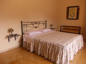 a bedroom with a large bed with a bedspread at Villa Costanza in Bobbio
