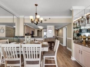a dining room and kitchen with a table and chairs at Jade East Towers 0730 by Newman-Dailey in Destin