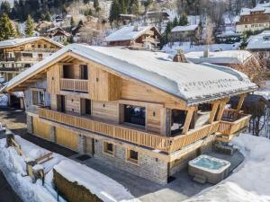 a log home in the snow with a snow covered roof at Chalet Megève, 7 pièces, 12 personnes - FR-1-569-10 in Megève