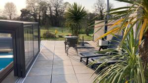 a patio with chairs and a table next to a pool at Desirad in La Clisse